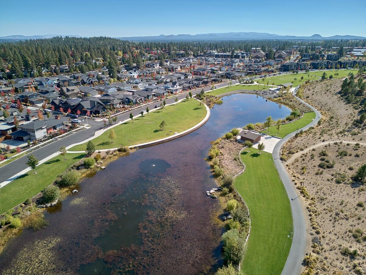 High aerial view showcasing luxury neighborhood in Northwest Crossing Bend Oregon with lake and park